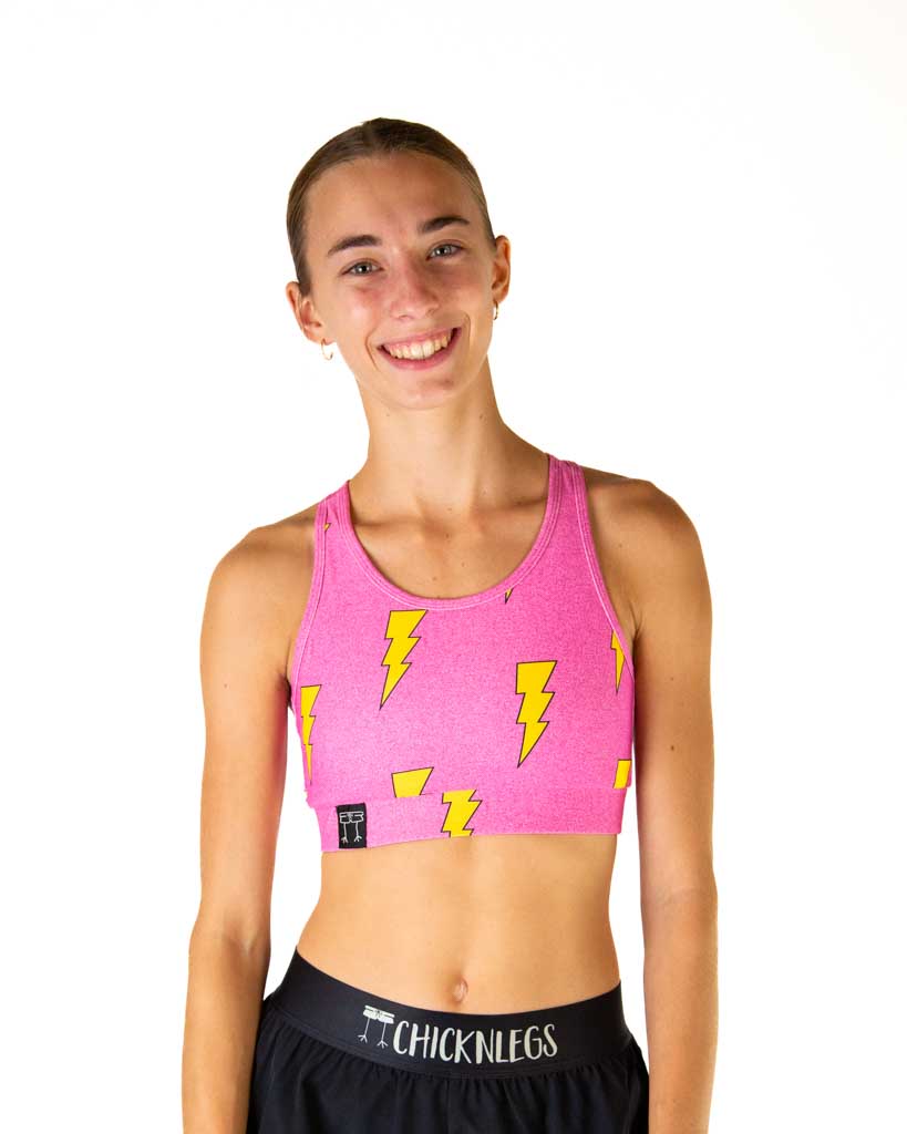 Front view of ChicknLegs women’s OG sports bra in hot pink lightning bolts design, featuring a back pocket and medium supportive fit.