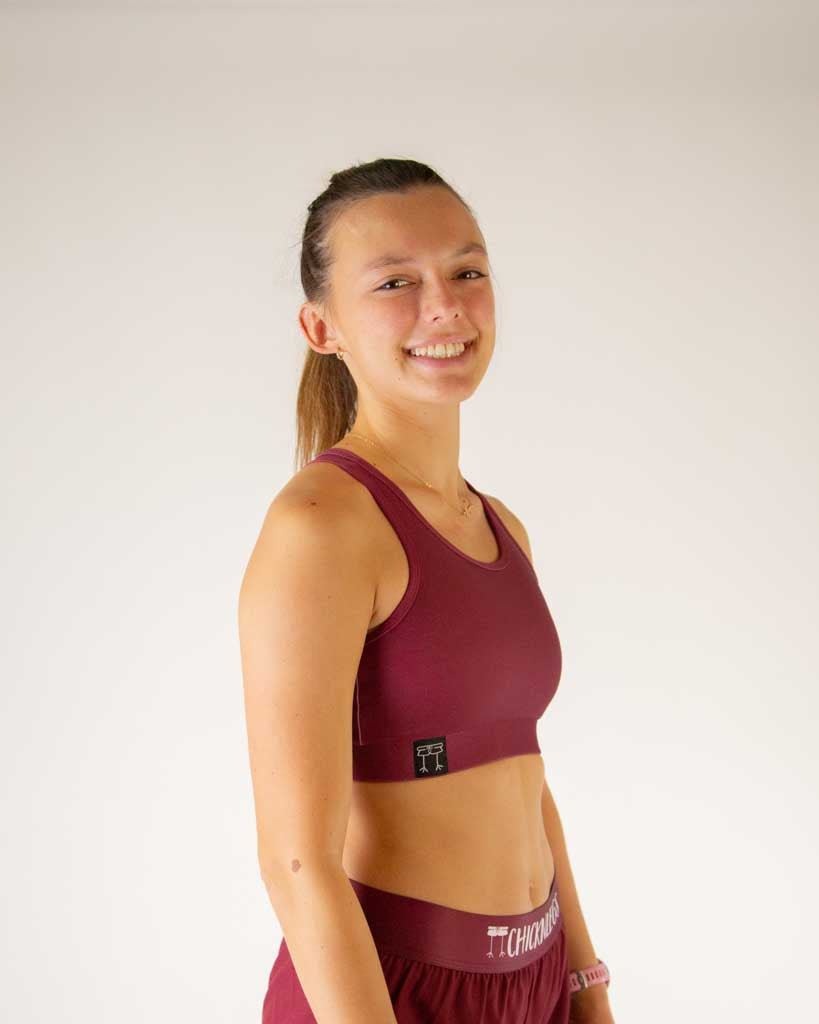 Right side view of ChicknLegs women’s og sports bra in solid maroon and elastic underband.