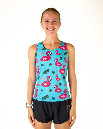 Front image of runner wearing ChicknLegs in the women's performance singlet in the Blue Flamingo print. A blue background fabric with bright pink flamingos are shown paired with a women's 1.5 inch black split running short.