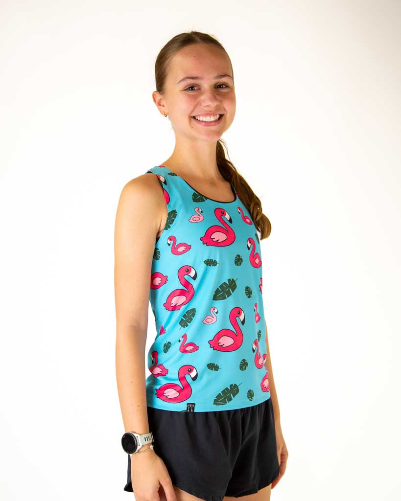 Right view of the runner wearing ChicknLegs in the women's performance running singlet in the blue flamingo print. 