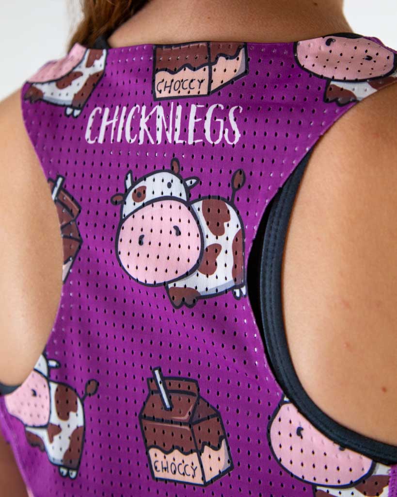 A close up image is shown of ChicknLegs women's performance running singlet in the choccy cow pattern, with a breathable mesh back.