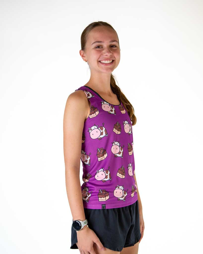 Right side view of runner wearing ChicknLegs in the women's performance running singlet in the choccy cow design and purple background.