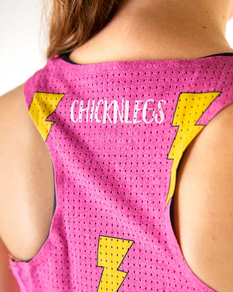 A close up shot is shown here of the runner wearing ChicknLegs in the hot pink fabric with yellow lightning bolts. Breathable mesh panelling back is shown.