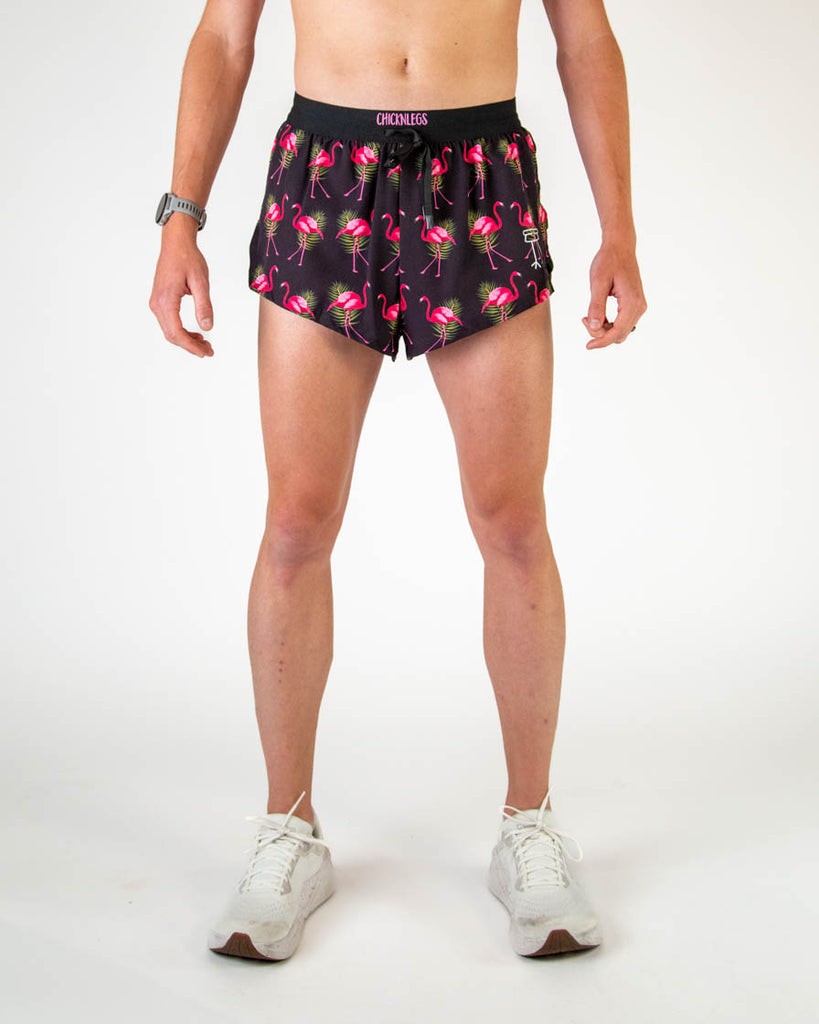 ChicknLegs Men's 2" DS drawstring shorts are shown on the runner. The print has hot pink flamingos with green leaves and a black background on it.
