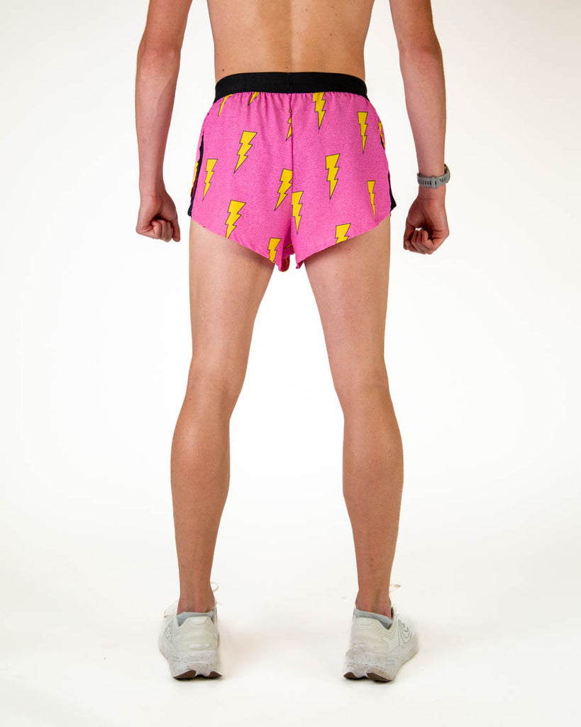 Back view of ChicknLegs men’s 2-inch split running shorts in hot pink with yellow lightning bolt pattern.
