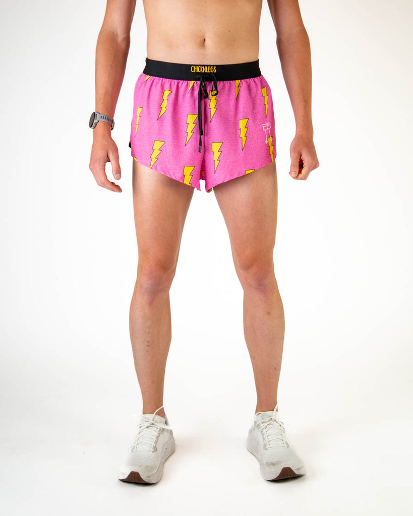 ChicknLegs men’s 2 inch split running shorts with drawstring and breathable liner, hot pink background with yellow lightning bolt design, no-chafe performance.