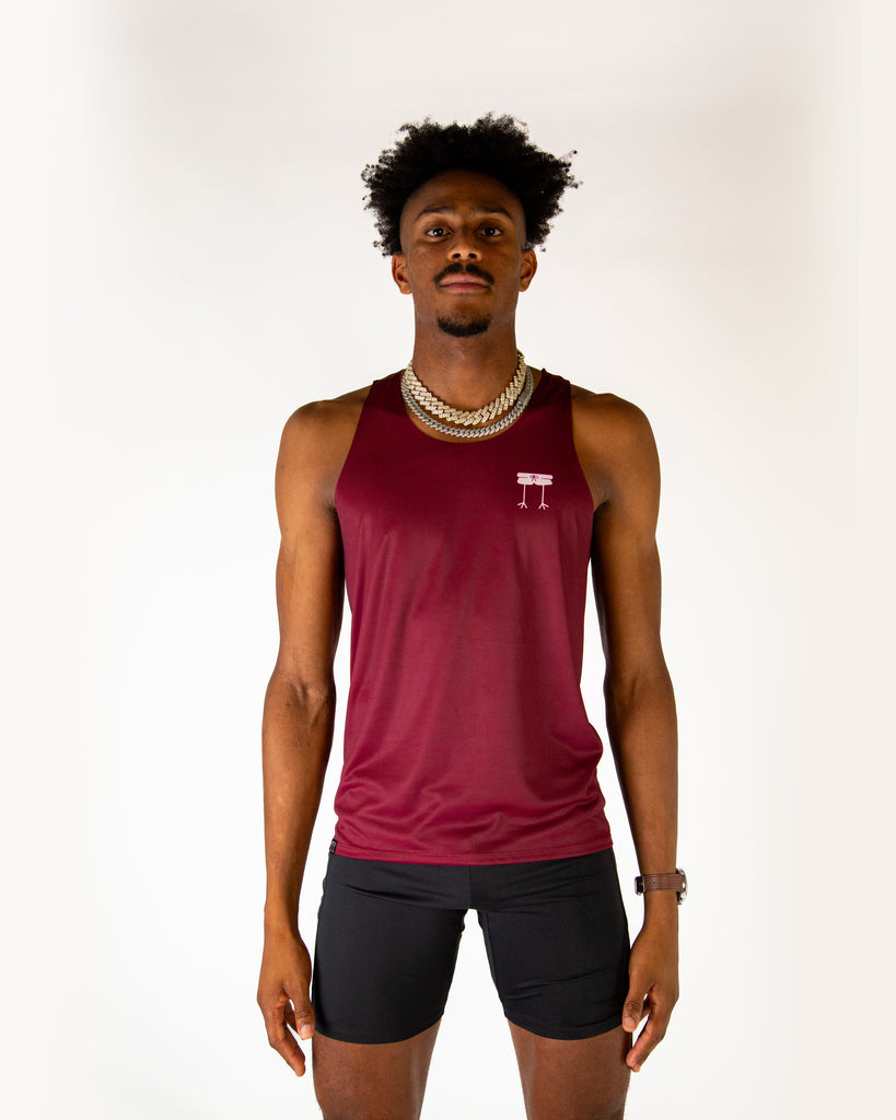 Runner is wearing ChicknLegs in the men's performance singlet in the maroon solid. Great for runners.