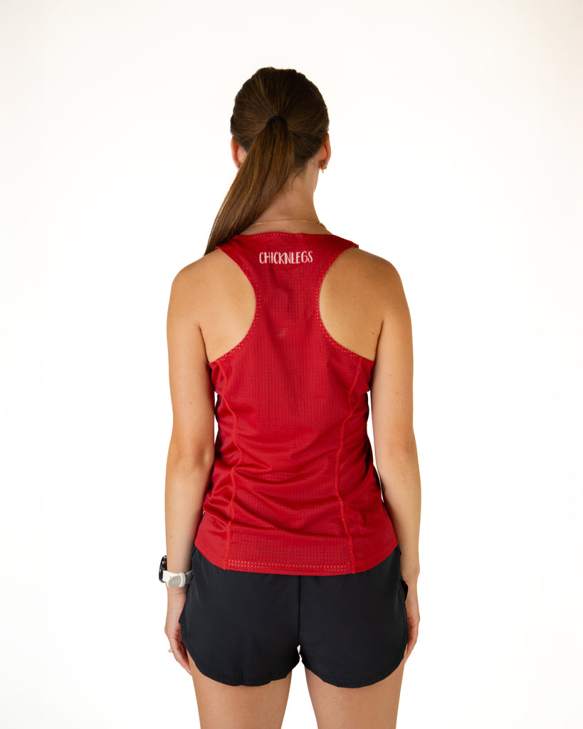 Runner is wearing ChicknLegs in the women's performance running singlet in the cardinal red solid color. Breathable mesh on the singlet is shown in the image to show the back view.