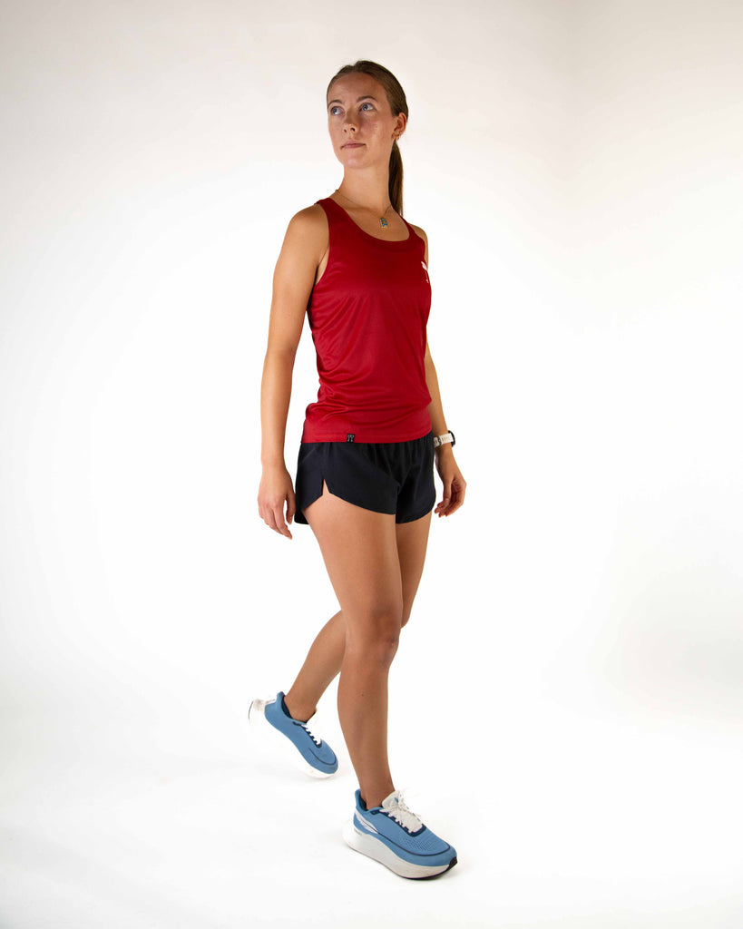 Full body view of model wearing the ChicknLegs Performance Running Singlet, featuring lightweight, breathable construction with mesh back panel and seamless armholes for a comfortable fit.