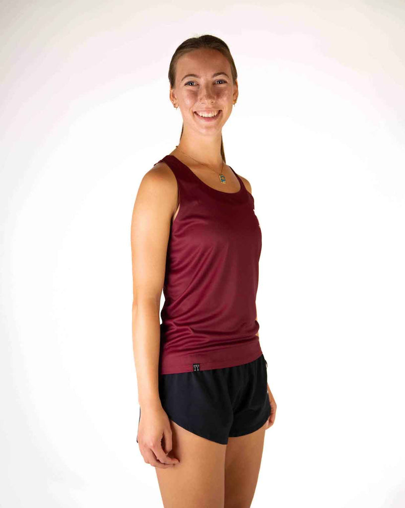 Right side view of ChicknLegs Women's Performance Running Singlet in the Maroon solid color, featuring the breathable, quick-dry fabric and seamless arm opening for a smooth fit.