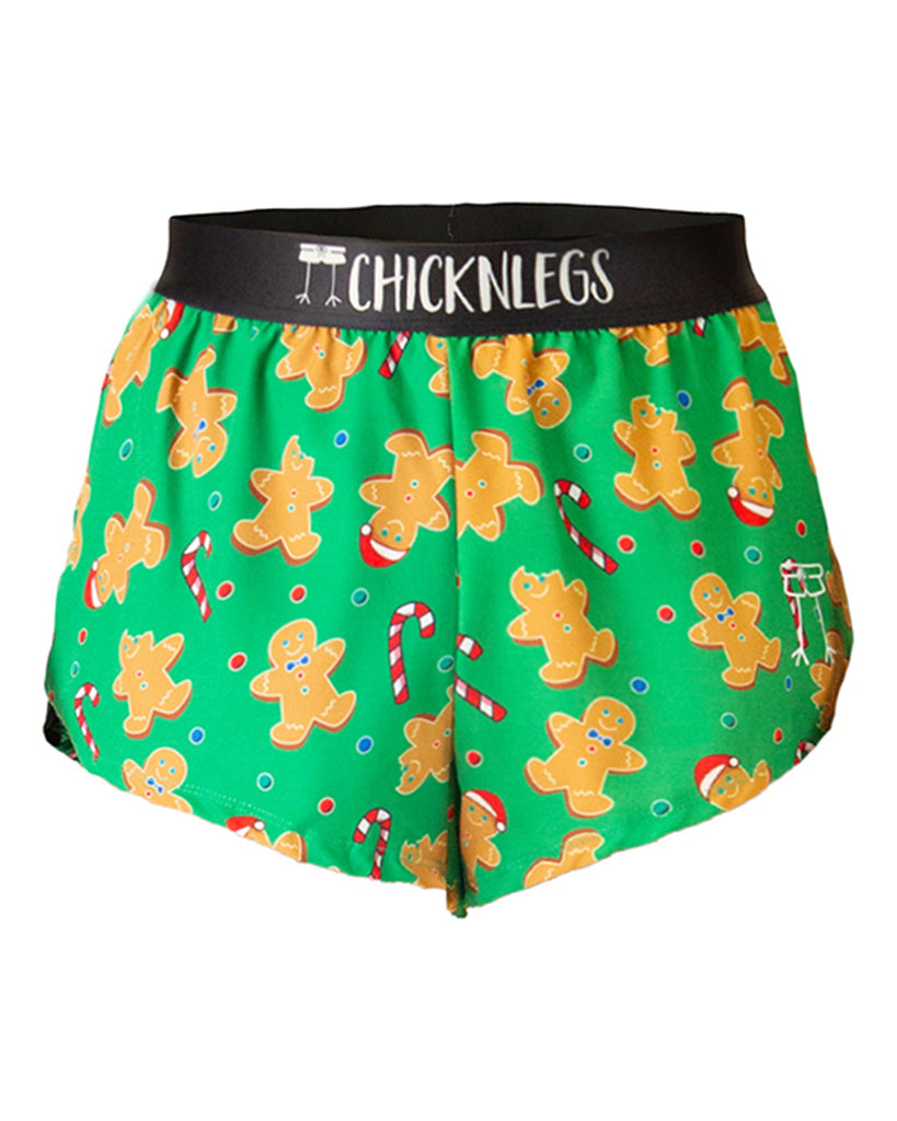 Ghost image is of ChicknLegs men's 2 in split running shorts of the gingy's revenge design. The print has gingerbread men, candy cans, and fun candy all over it that are red, white, brown and green.