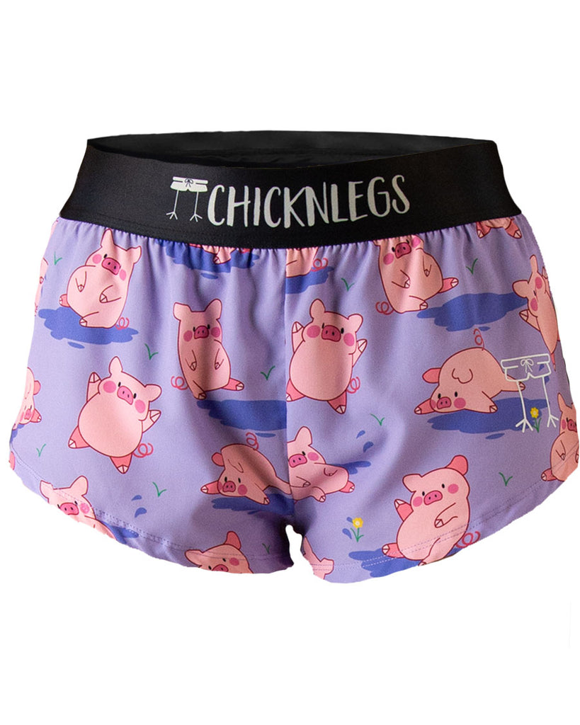 Ghost image of ChicknLegs women’s 1.5-inch split running shorts with drawstring, breathable liner, lilac purple background and pink piggies design.
