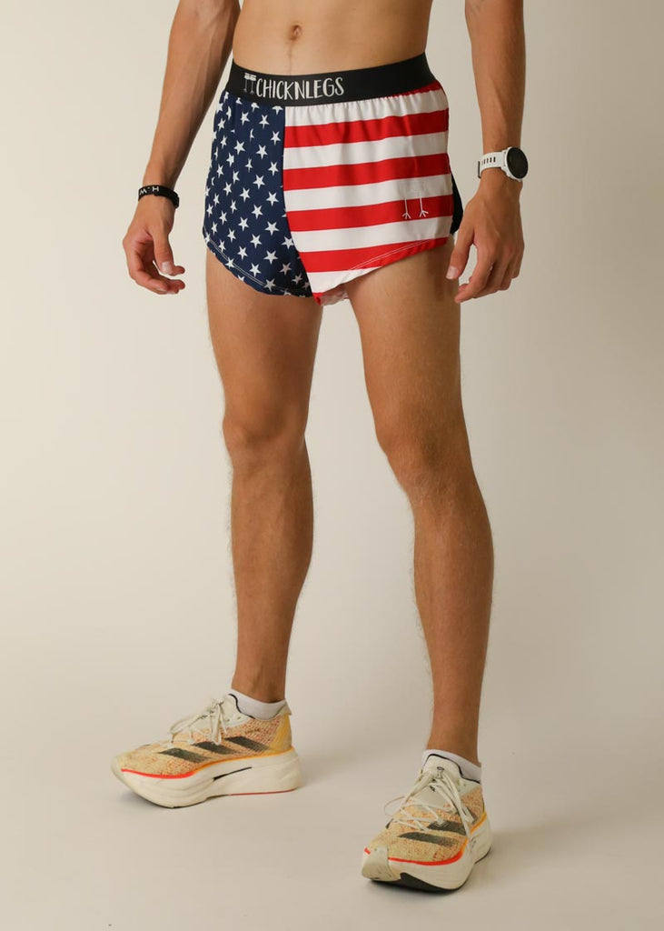 Model wearing Chicknlegs in men's 2 inch split running shorts in the usa design, facing left for left view.