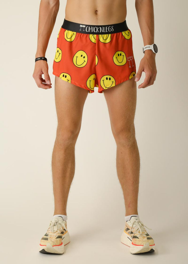 Model wearing Chicknlegs men's 2 inch split running shorts in the smiley, facing front.