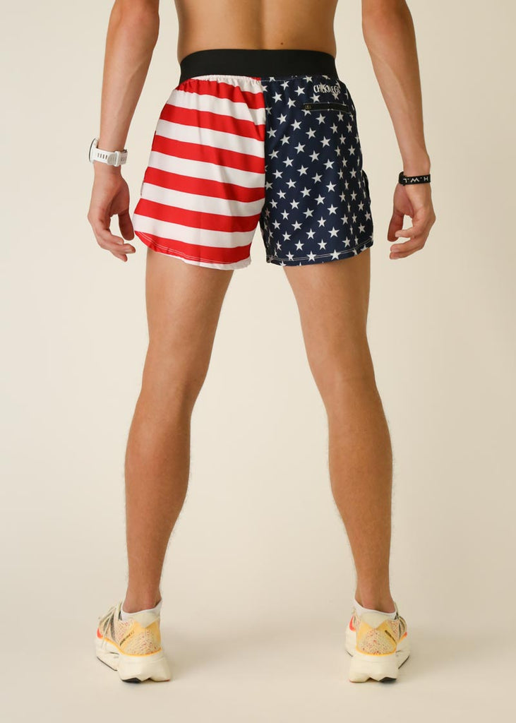 Model wearing Chicknlegs in men's 4 inch split running shorts in the usa design, facing back for side view.