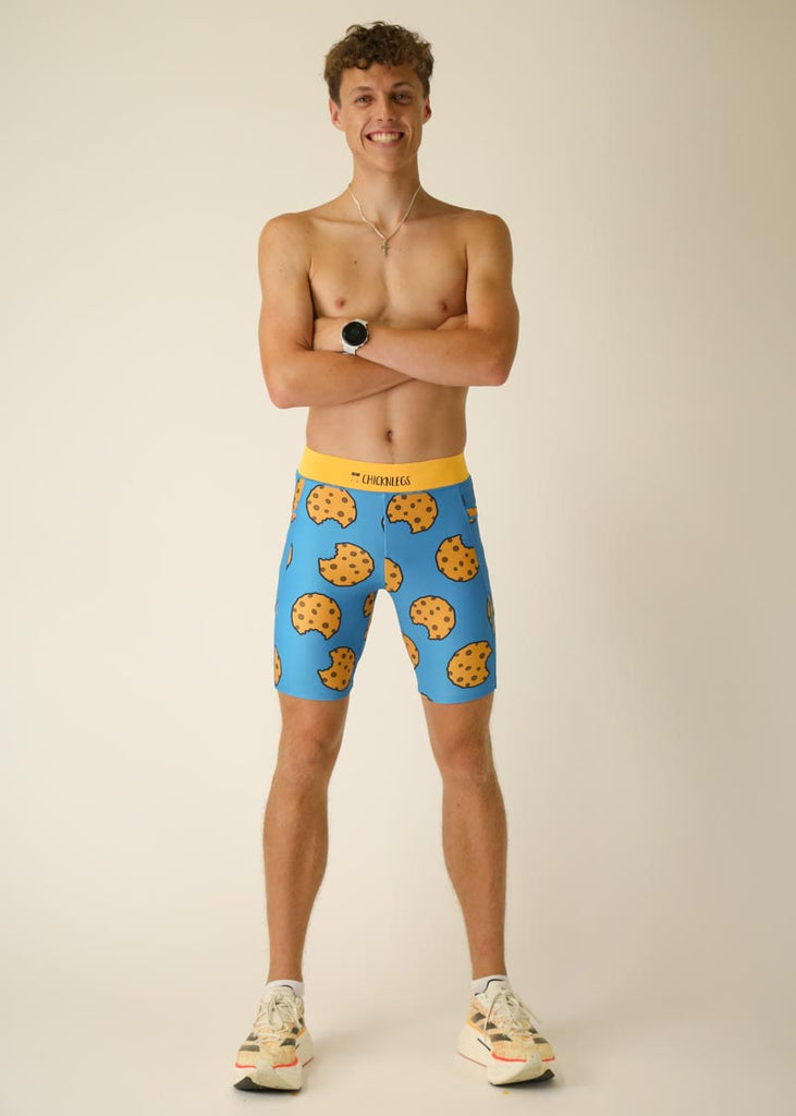 Model wearing Chicknlegs men's 8 inch half tights in the cookies design, full body pose while crossing arms.