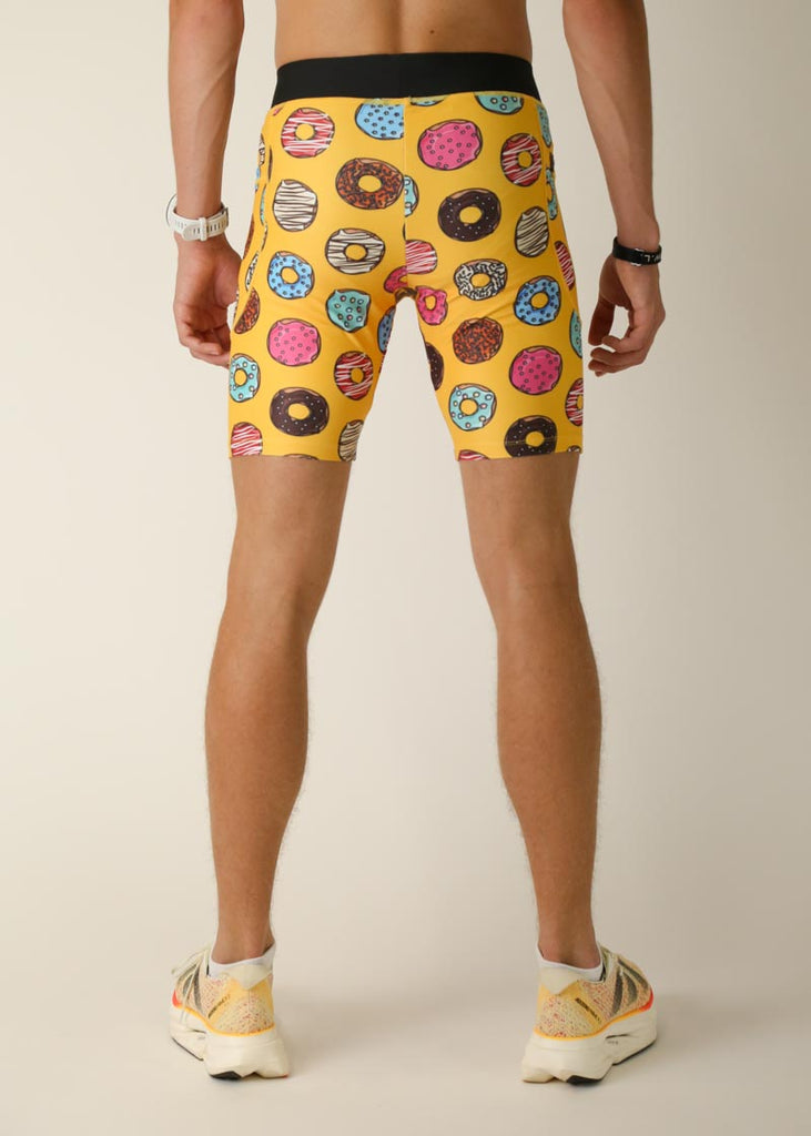 Model wearing Chicknlegs men's 8 inch half tights in the salty donuts design, back view.