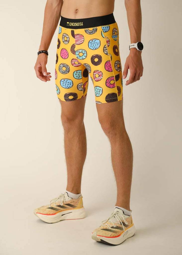 Model wearing Chicknlegs men's 8 inch half tights in the salty donuts design, left view.