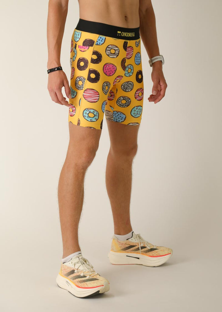 Model wearing Chicknlegs men's 8 inch half tights in the salty donuts design,  right view.