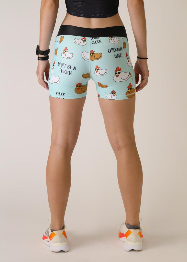 Model is wearing Chicknlegs women's 3 inch compression shorts for running in the swaggy chicken design, facing the back.