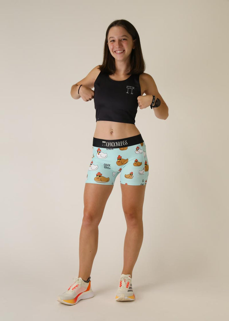 Model is wearing Chicknlegs women's 3 inch compression shorts for running in the swaggy chicken design, posing doing the chicken dance.