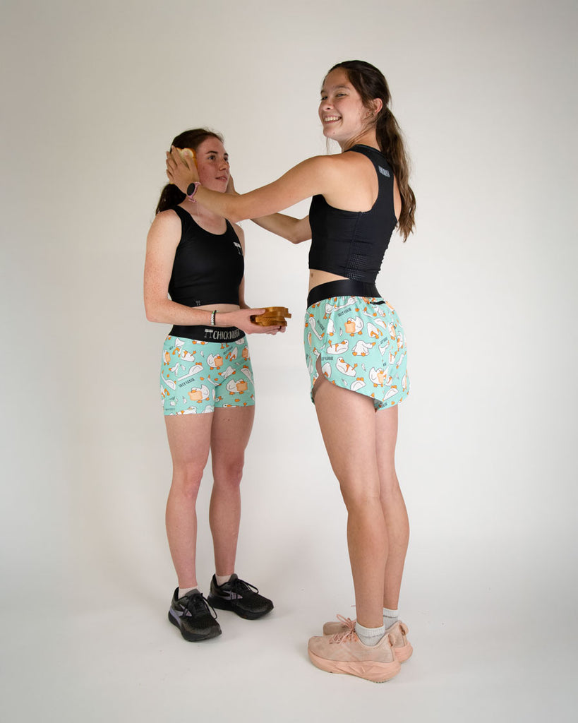 Runners are wearing the women's 1.5 in, and 4 in shorts. They are all wearing the silly goose print while holding bread.