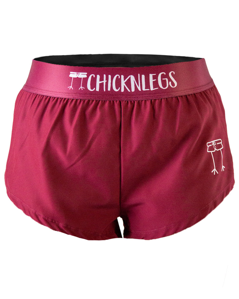 Close-up ghost image of ChicknLegs women’s 1.5-inch running shorts, solid maroon fabric waistband.