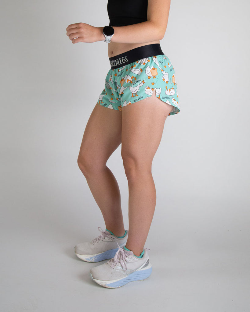 Runner is wearing ChicknLegs in the women's 1.5 split running shorts in the silly goose design. The print has yellow, white, orange, and blue on it.