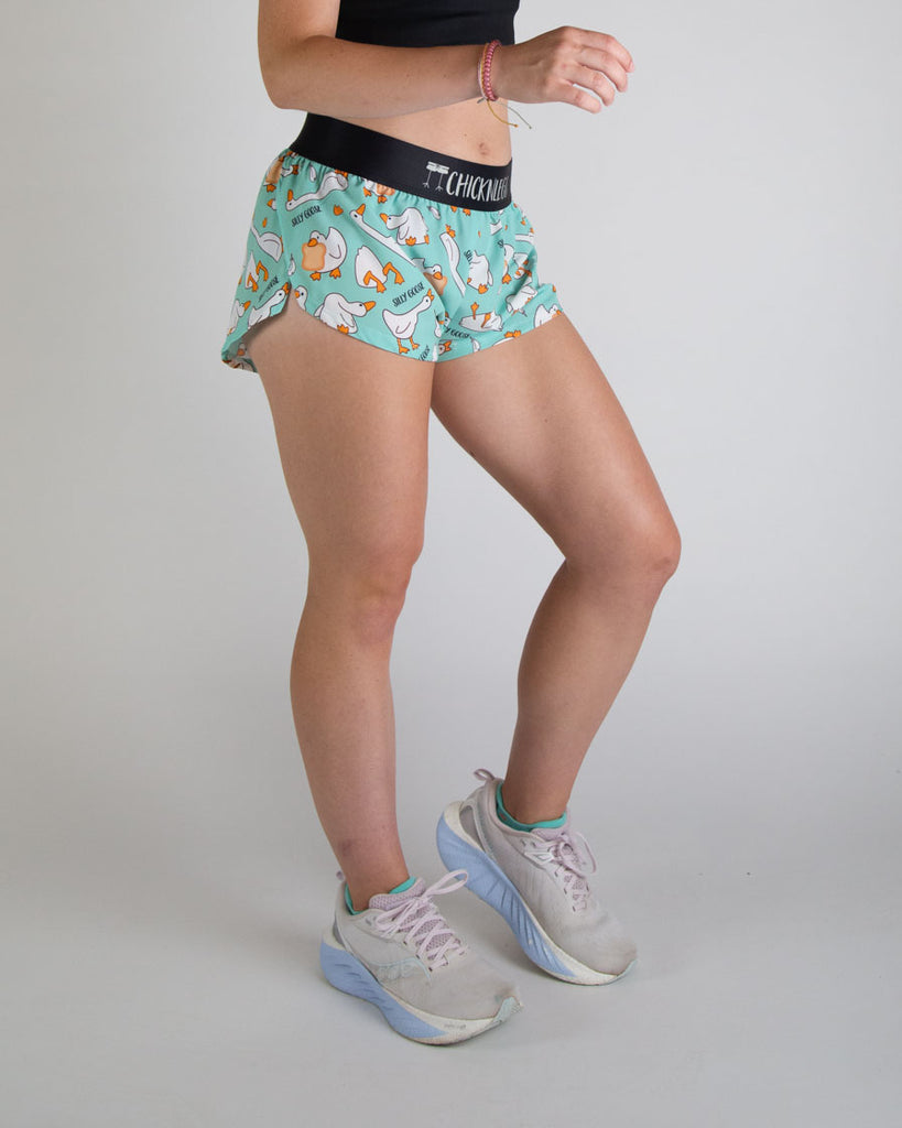 Runner is wearing ChicknLegs in the women's 1.5 in split running shorts. The print has white, orange and blue on it with funny silly goose and bread on it. Great for workouts, working out, weight lifting, volley, running, hiking, and track and field!