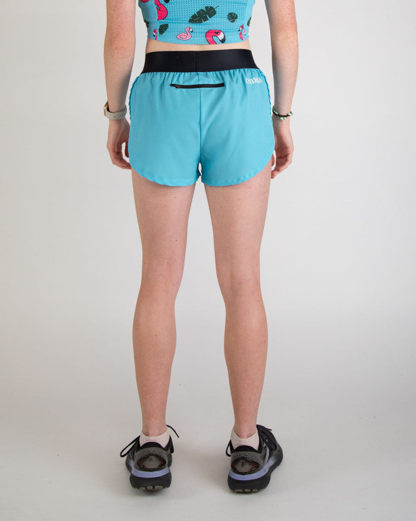 Runner is wearing ChicknLegs in the women's 1.5 in split running shorts in the solid color, sky blue design. Shorts include a back zipper to carry phones, iphones, androids, snacks, keys, or gels.