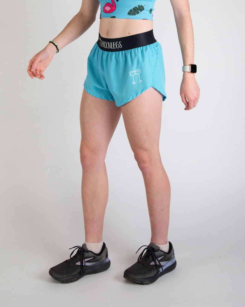 Runner is wearing ChicknLegs in the women's 1.5 in split running shorts in the solid color, sky blue design. This is great for matching fits with the blue flaming.