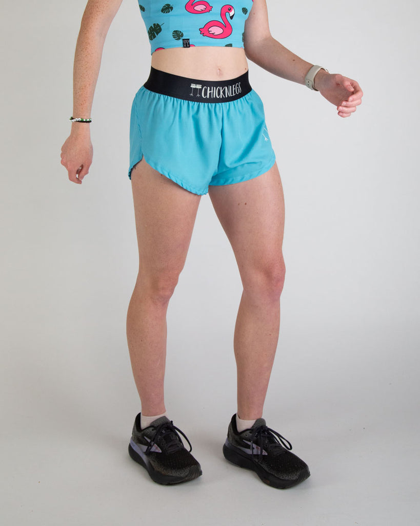 Runner is wearing ChicknLegs in the women's 1.5 in split running shorts in the solid color, sky blue design. Great for working out, weight lifting, track and field, hiking, pickle ball and more!