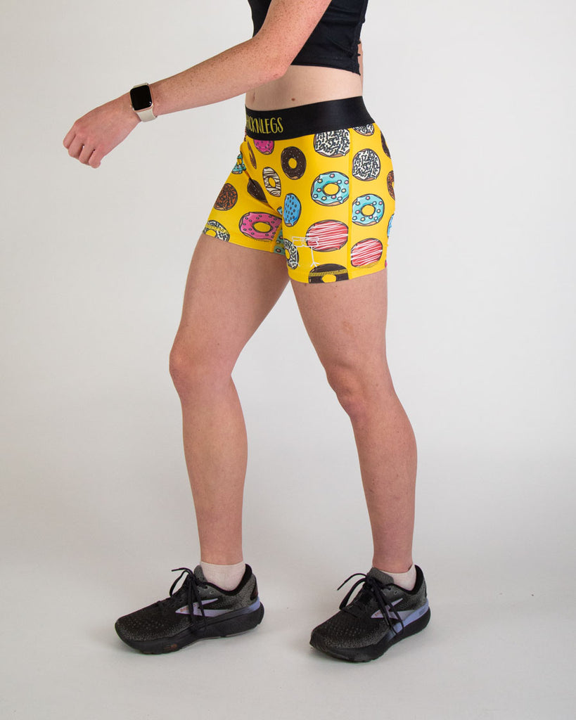 Runner is wearing ChicknLegs in the women's 3 in compression spandex shorts in the salty donuts design. Fun print with food in blue, brown, pink, yellow, red, orange, green, colors! Material is soft and helps with no chaffing.