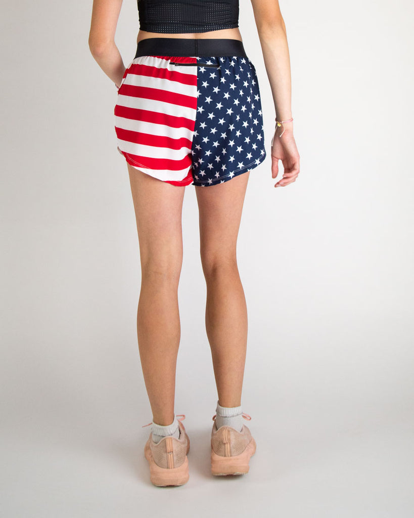 Runner is wearing ChicknLegs in the women's 4 in split running shorts in the USA state flag design.
