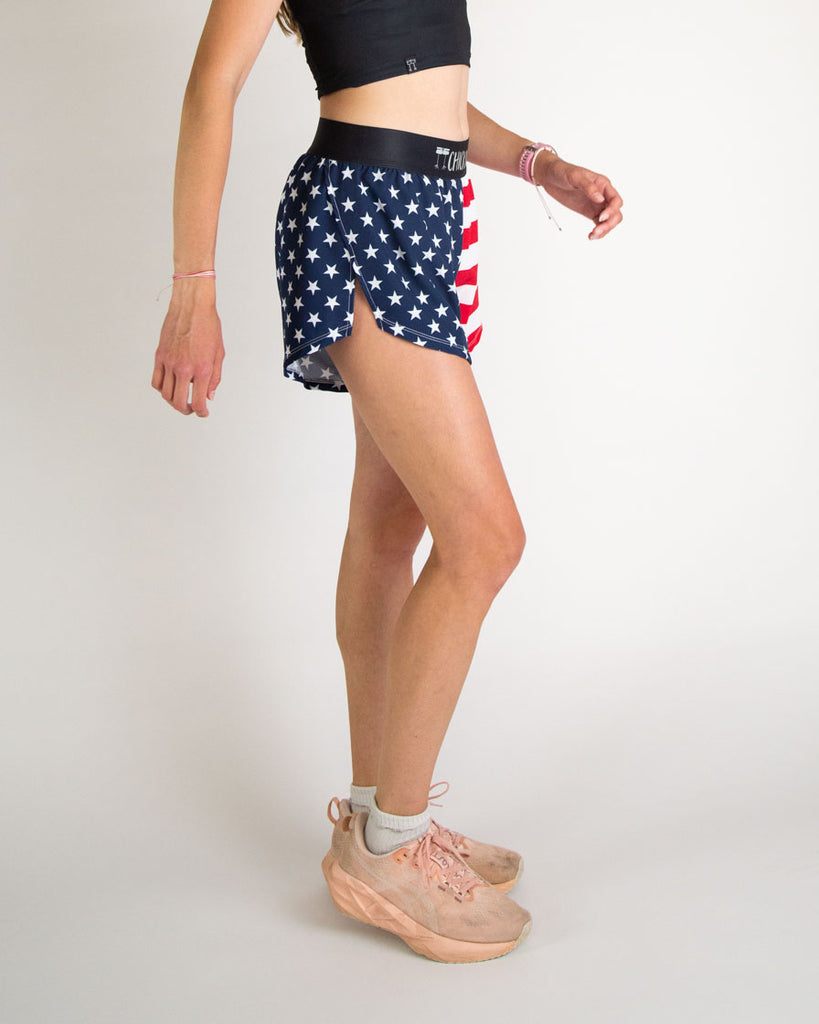 Runner is wearing ChicknLegs in the women's 4 in split running shorts in the USA state flag design. The print has red white and blue on it with white and red stripes and white stars on it.