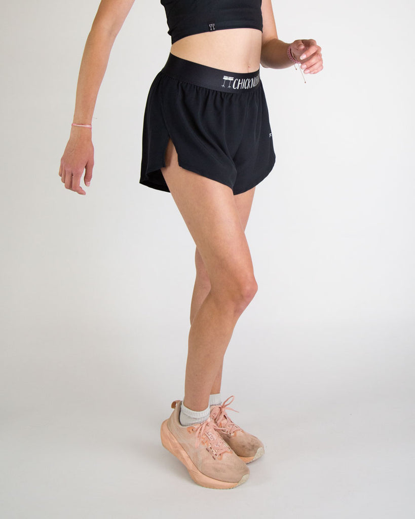 Runner is wearing ChicknLegs in the women's 4 in split running shorts in the solid black design. The print is great for matching sleek fits that go great with other prints or products. Great shorts to wear during workouts, weight lifting, hiking, and track and field.