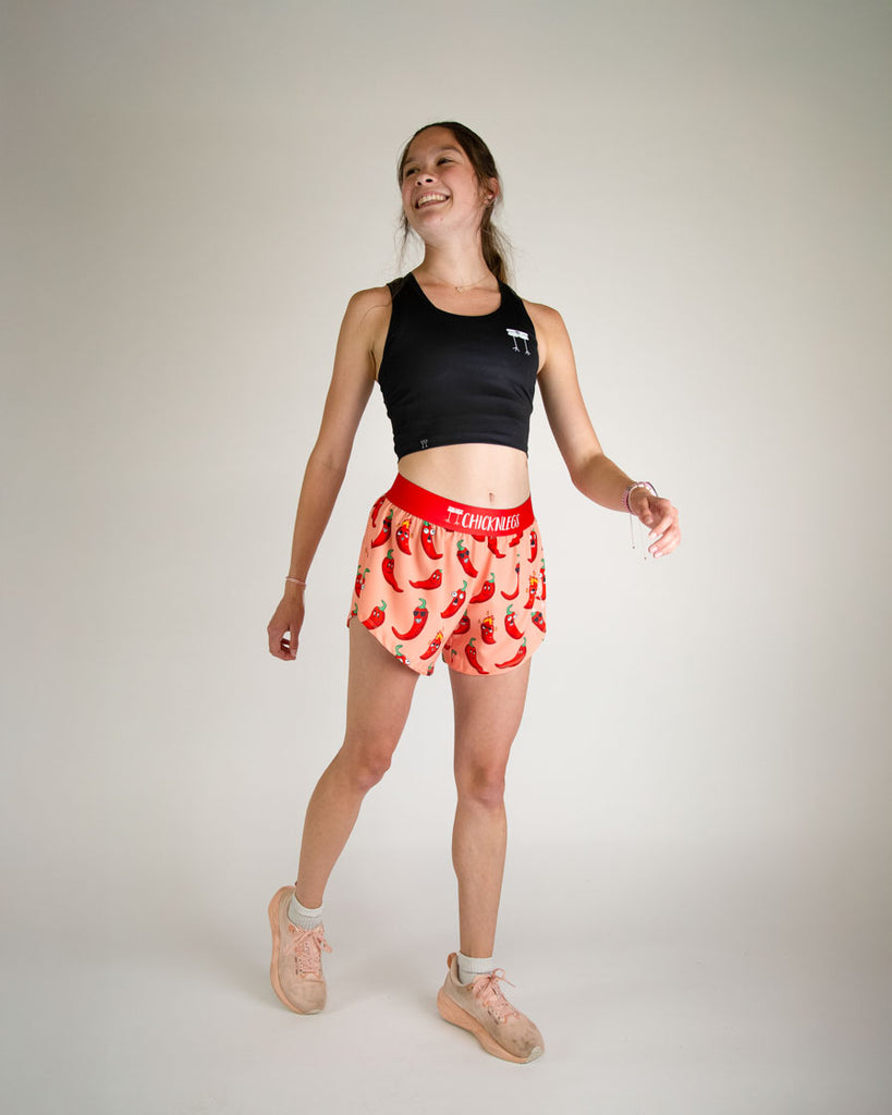 Runner is wearing ChicknLegs in the women's 4 in split running shorts in the chili pepper design. The print has fun red, green and orange all over it for people who love spicy. 