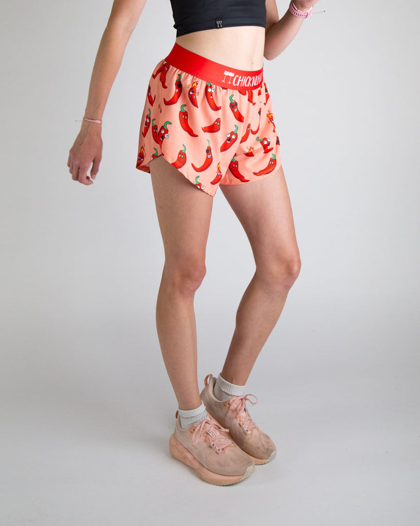 Runner is wearing ChicknLegs in the women's 4 in split running shorts in the chili pepper design. The print has fun red, green and orange all over it for people who love spicy. Great for running, track and field, volley ball, biking, cycling, weightlifting and working out.