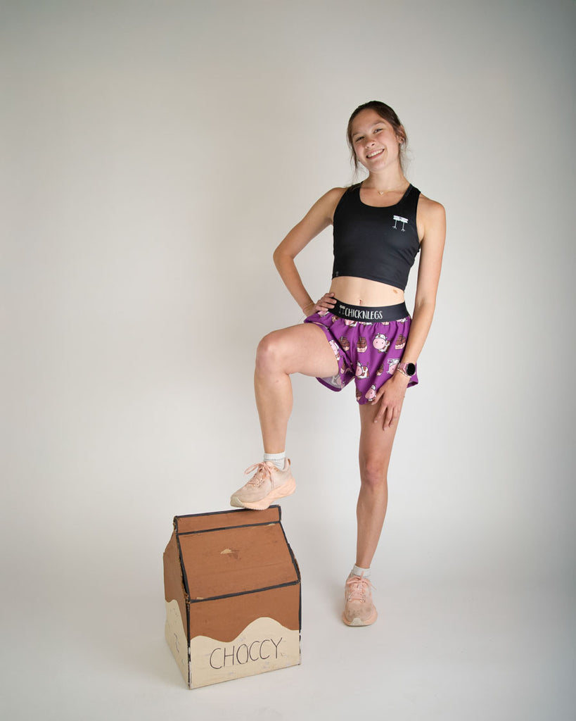 Runner is wearing ChicknLegs in the women's 4 in split running shorts in the choccy cow design. The print has brown cows on it with chocolate milk. Great for workouts, running, long distance, volley ball, working out, weight lifting, hiking, and track and field!