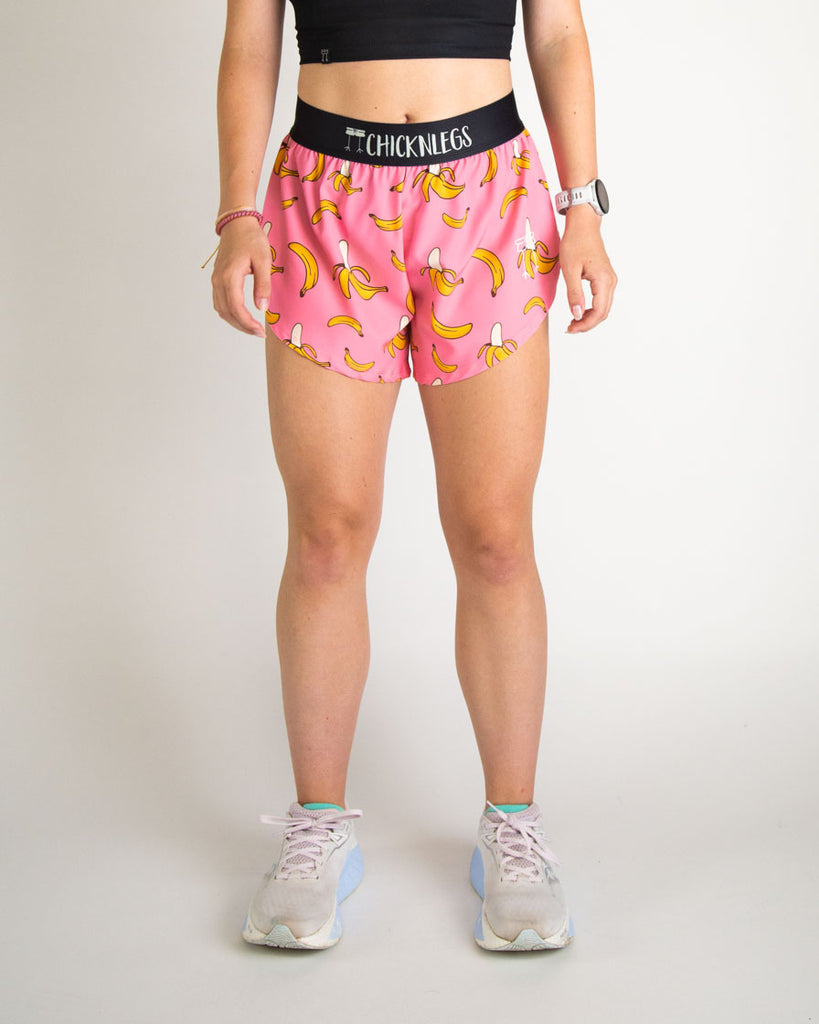 Runner is wearing ChicknLegs in the women's 4 in split running shorts in the pink banana shorts. The print has yellow and pink on it. Great for food lovers.