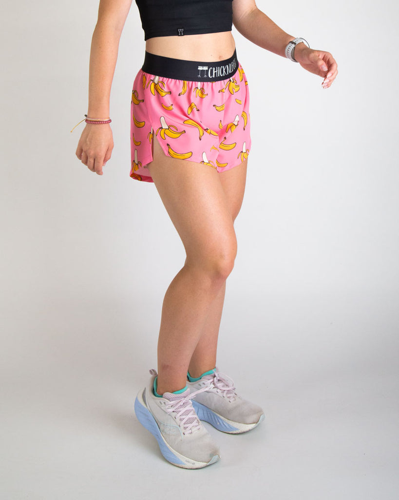 Runner is wearing ChicknLegs in the women's 4 in split running shorts in the pink banana shorts. The print has yellow and pink on it. 