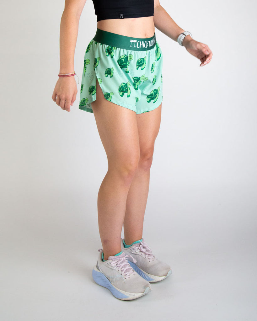 Runner is wearing ChicknLegs in the women's 4 in split running shorts. The print has sea turtles on it that are green with bubbles. Great for animal and turtle lovers.