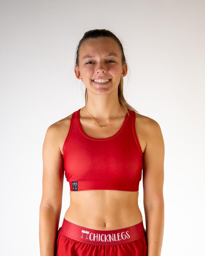 Front view of ChicknLegs women’s og sports bra with light  support, solid cardinal red fabric and scoop neckline.
