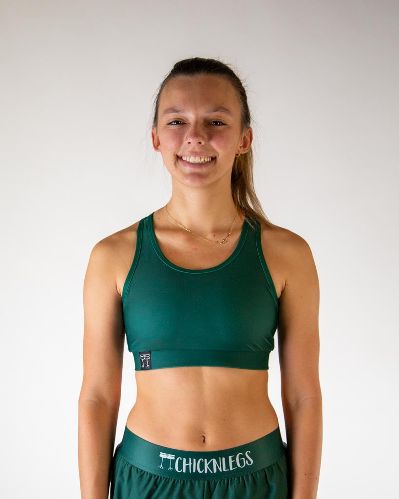 Front view of ChicknLegs women’s OG sports bra with light support, forest green fabric, and scoop neckline.