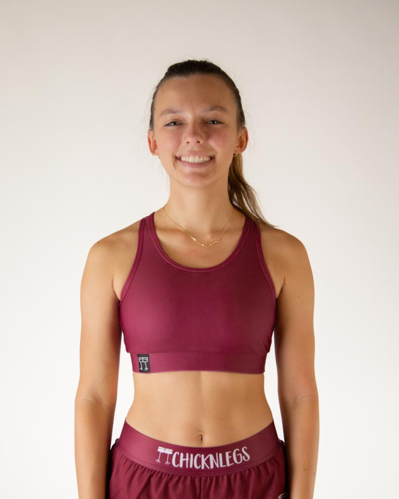 Front view of ChicknLegs women’s og sports bra with light support, solid maroon fabric and scoop neckline.