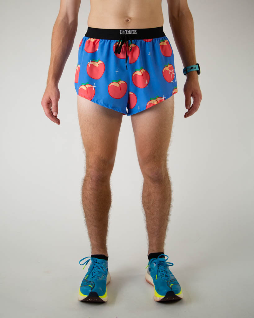 Front view of ChicknLegs men’s 2-inch split running shorts with drawstring, breathable liner, blue background and juicy peaches design.