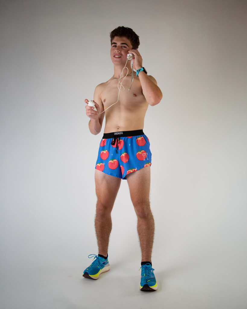 Full body view of ChicknLegs men’s 2-inch split running shorts with drawstring, breathable liner, blue background and juicy peaches design.