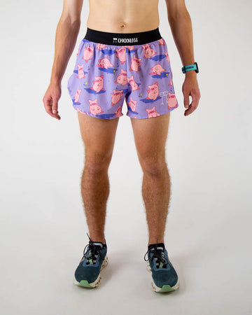 Front view of ChicknLegs men’s 4-inch split running shorts, breathable liner, lilac purple background and pink piggies on the design.
