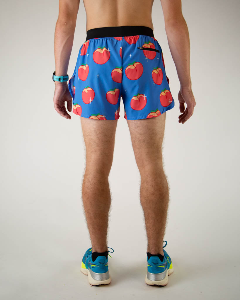 Back view of ChicknLegs men’s 4-inch split running shorts with, breathable liner, blue background and juicy peaches on the design.