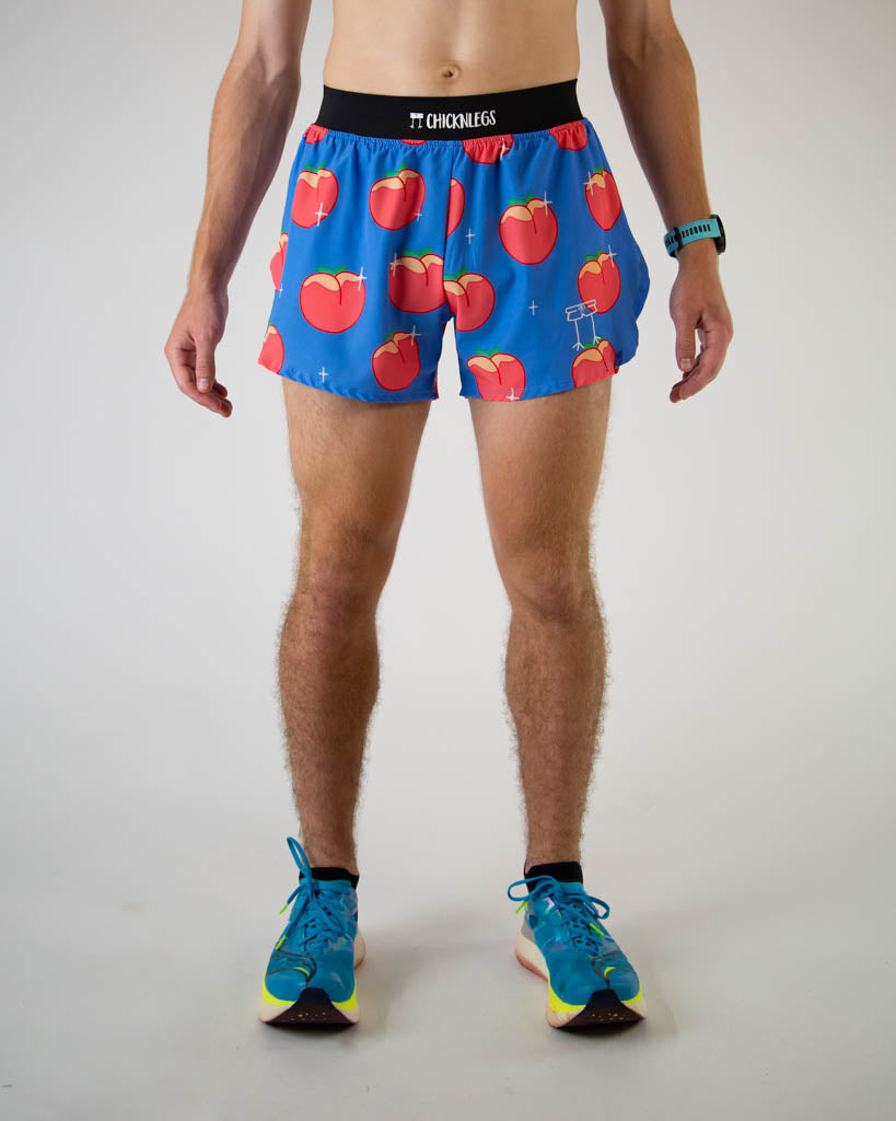 Front view of ChicknLegs men’s 4-inch split running shorts with, breathable liner, blue background and juicy peaches on the design.